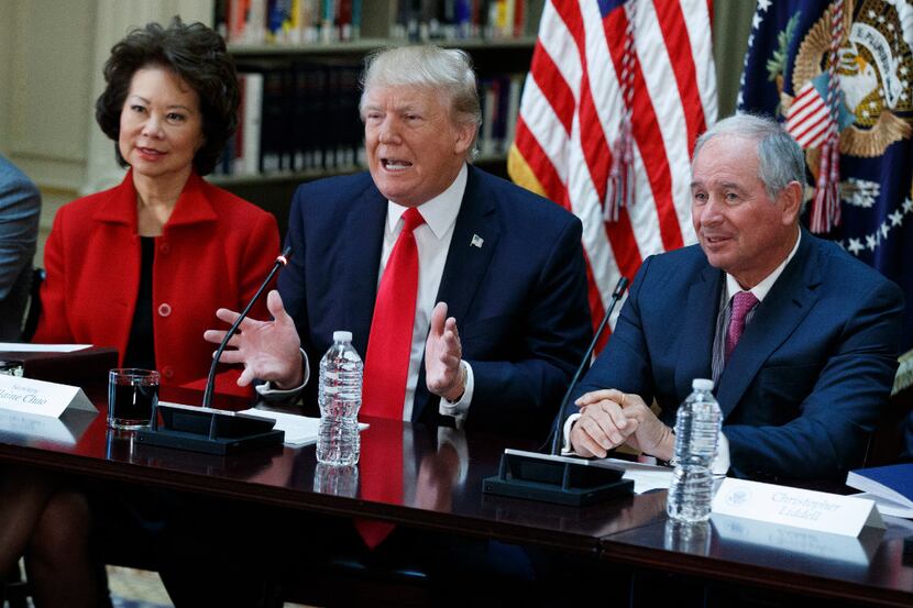 President Donald Trump, flanked by Transportation Secretary Elaine Chao and Blackstone Group...