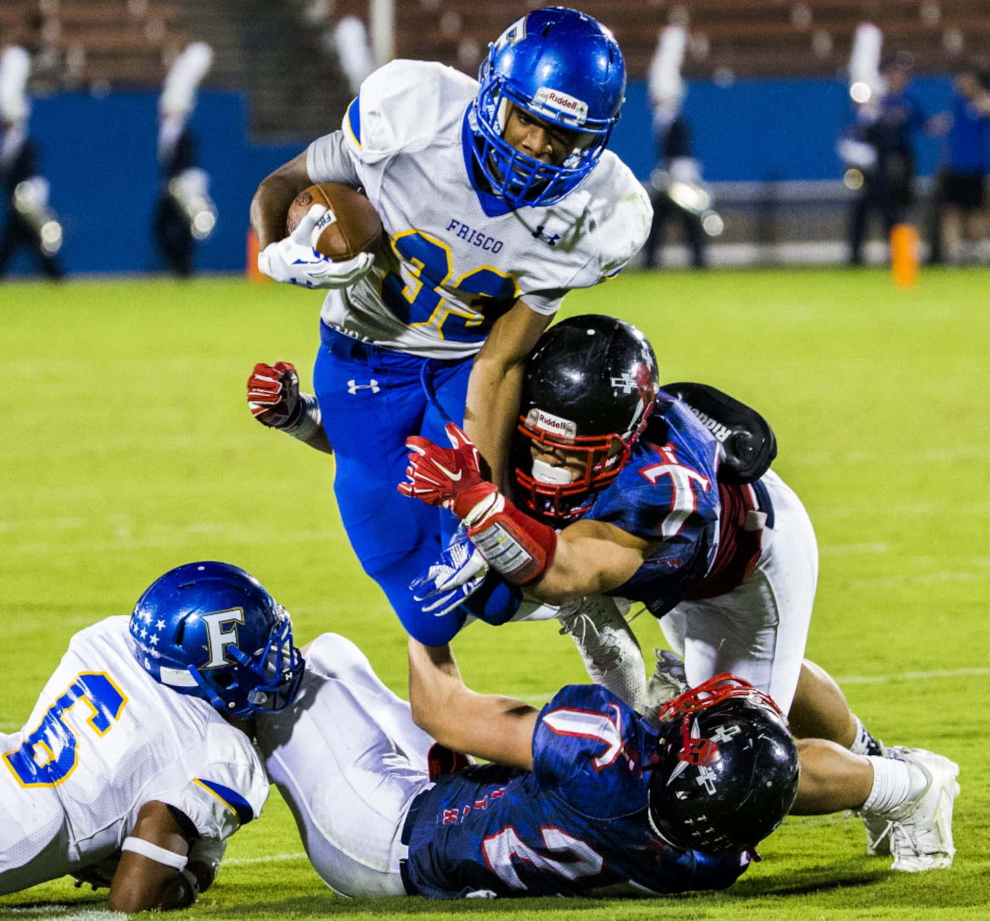 Frisco fullback Idrees Ali (33) is tackled by Frisco Centennial linebacker Alec Mlkovitz...