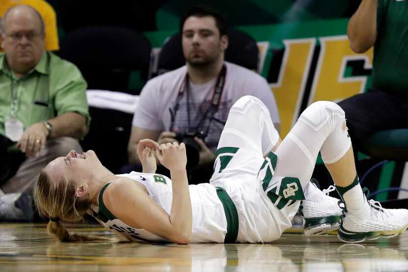 Baylor guard Kristy Wallace (4), of Australia, lies on the court after suffering an unknown...