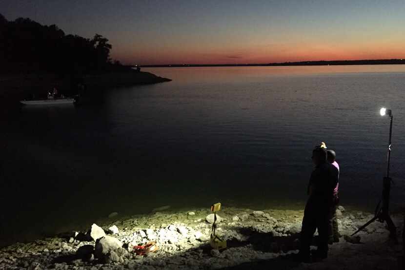 Dive crews search for the body of a missing swimmer Wednesday evening at Lake Benbrook.