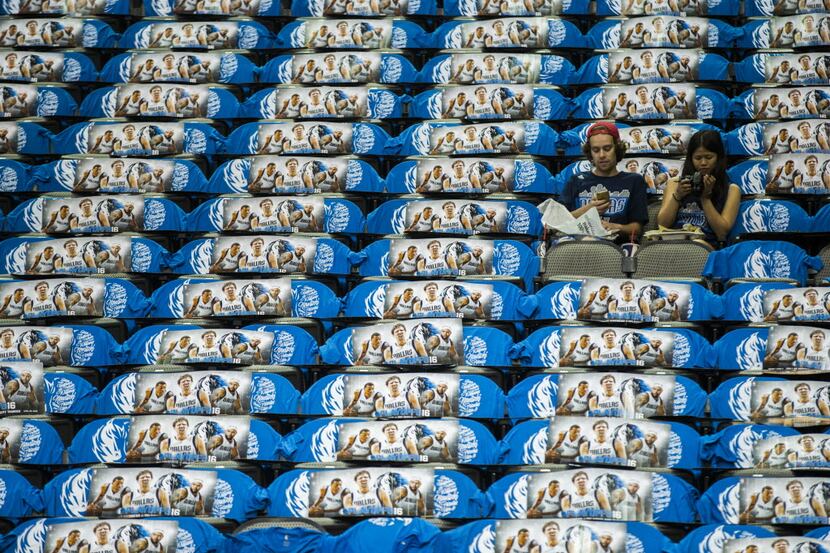 Two Dallas Mavericks fans take their seats before game 4 of their series against the...