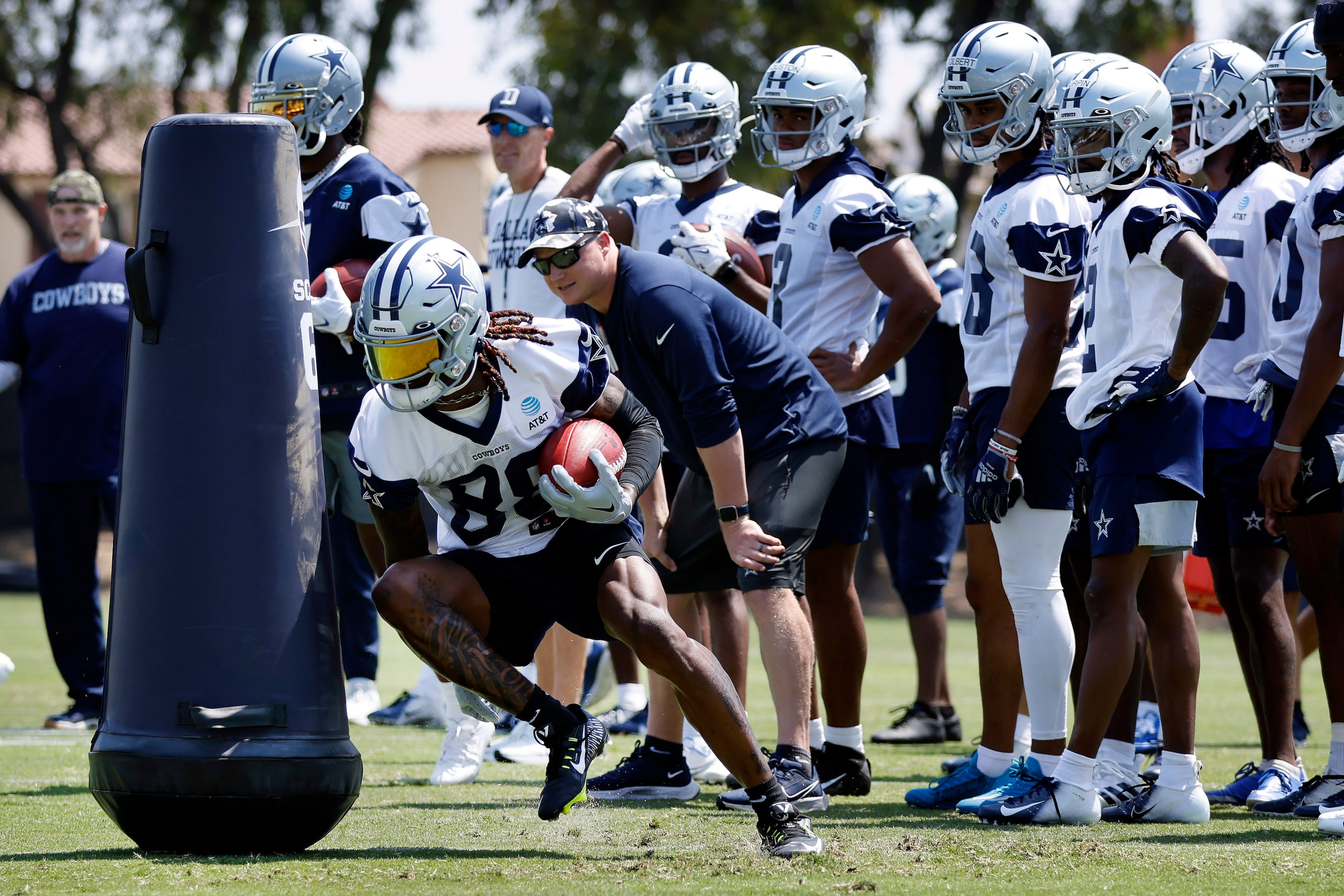 Dallas Cowboys wide receiver CeeDee Lamb (88)  digs around a blocking dummy as he carries...