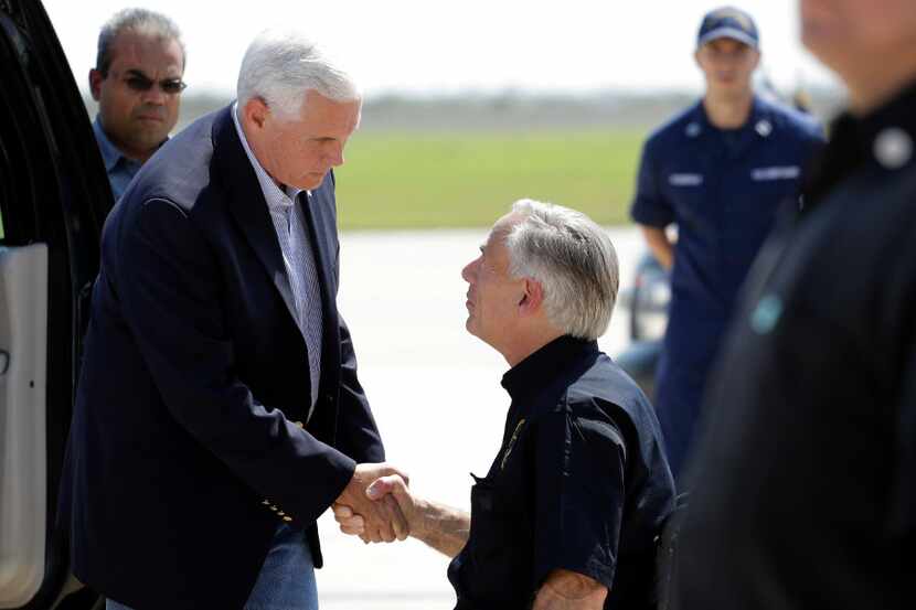 Vice President Mike Pence, left, and Texas Gov. Greg Abbott, right, talk as they prepare to...