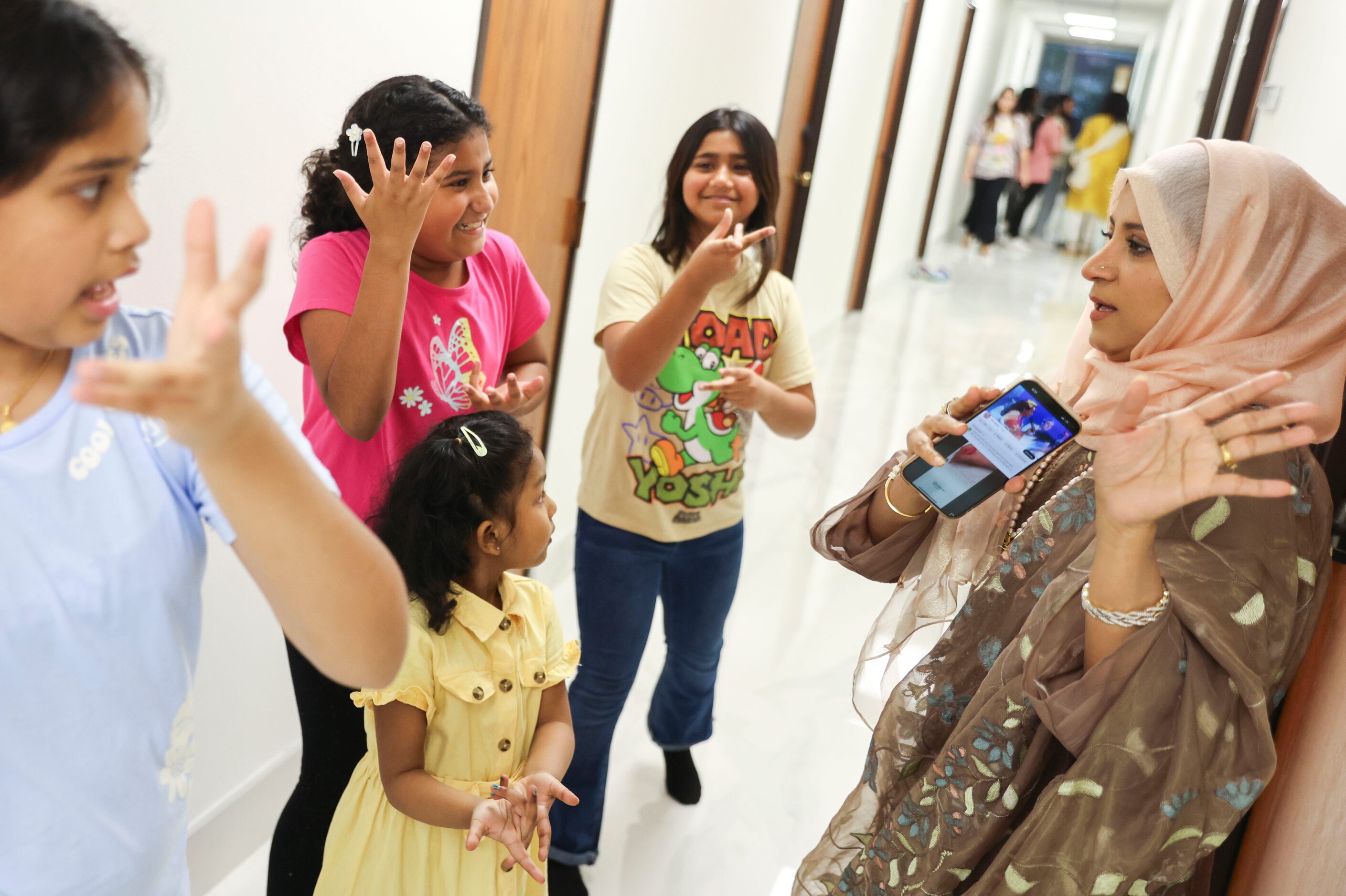 Rasida Rubina Rumi (right), with Bangladesh Association Of North Texas leads a dance...