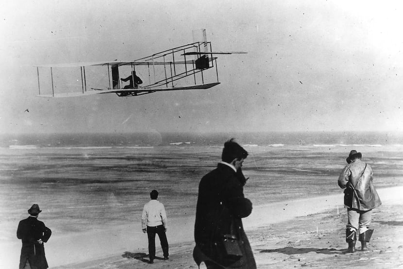 In this undated file photo, Orville and Wilbur Wright test their airplane on a beach. The...