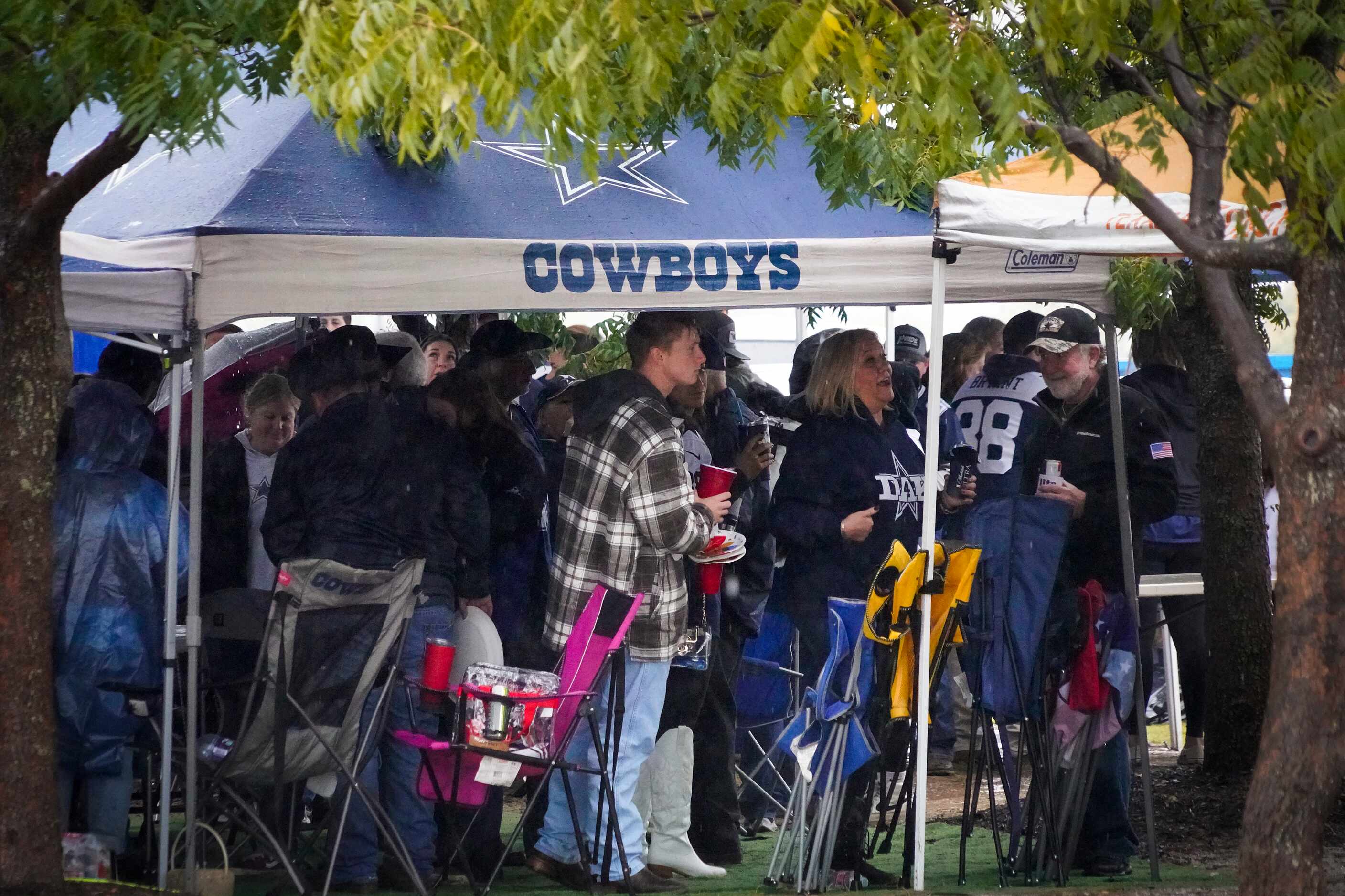 Fans tailgate in the rain before an NFL football game between the Dallas Cowboys and the New...