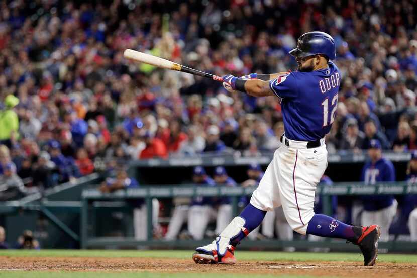 ARLINGTON, TX - APRIL 26: Rougned Odor #12 of the Texas Rangers hits a two-run single during...