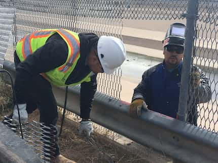 A two-person welding crew in El Paso replaces a section of border fence that was damaged...