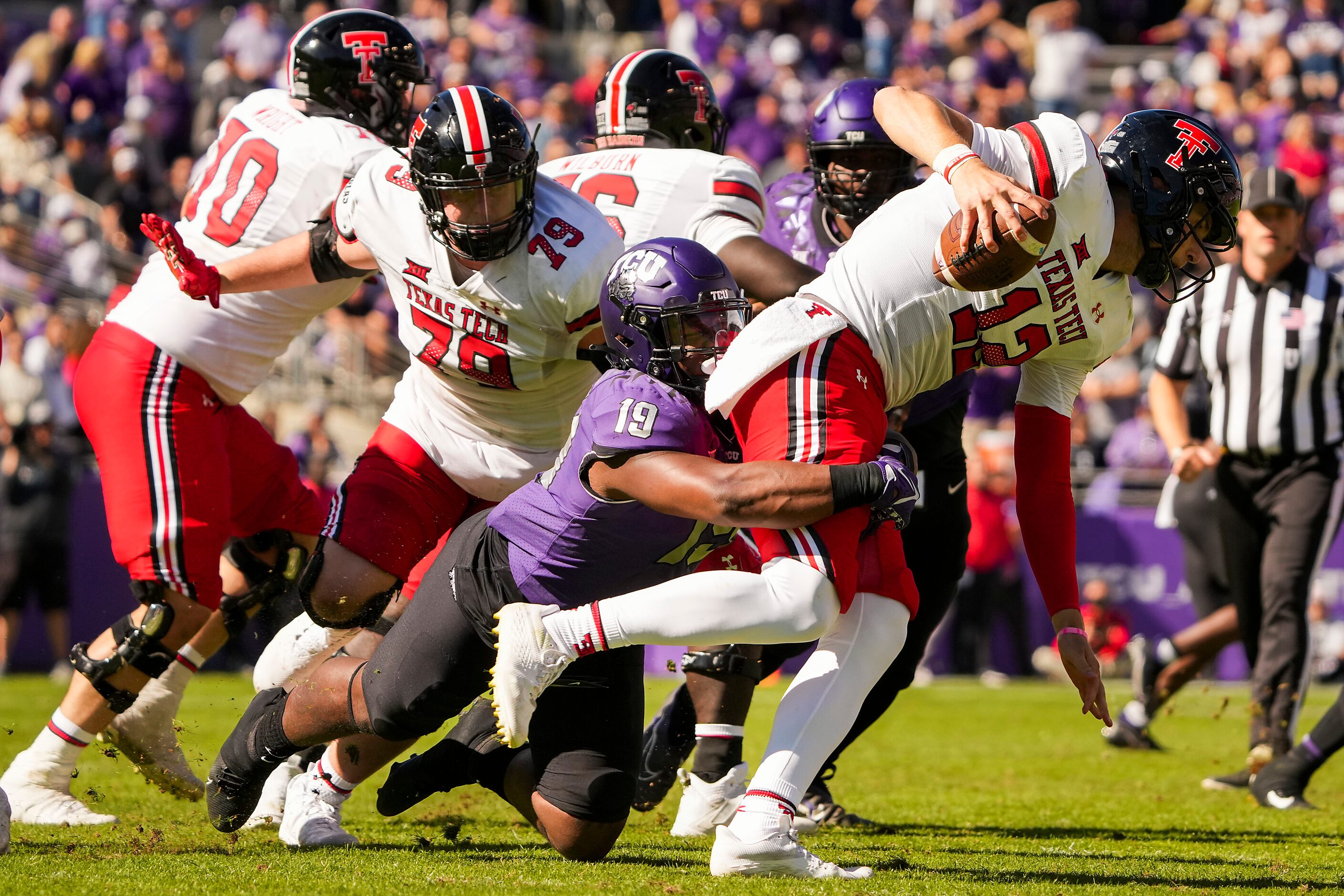 Texas Tech quarterback Tyler Shough (12) is sacked by TCU linebacker Shadrach Banks (19)...