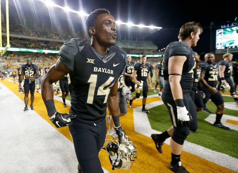 FILE - Baylor wide receiver Chris Platt (14) and other players walk off the fields after a...