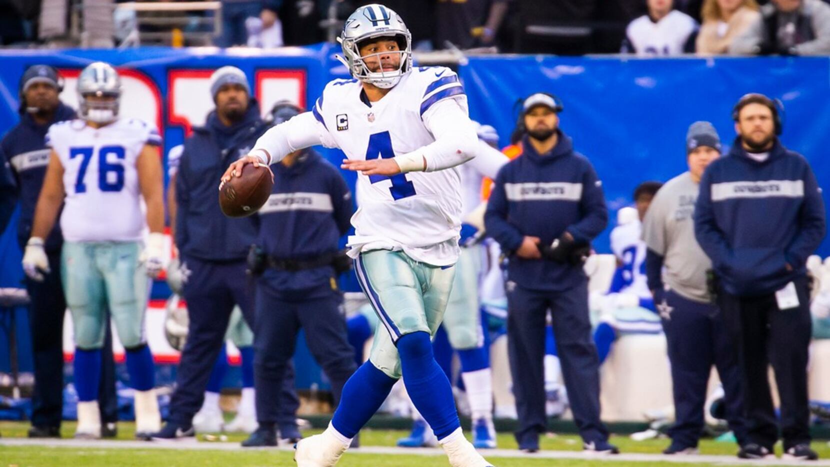 Dallas Cowboys quarterback Dak Prescott (4) scrambles away and throws a 32-yard touchdown ...