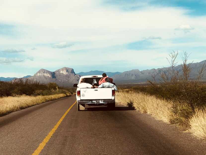 Fermin Compean (orange shirt) rides in back of truck near San Luis de Cordero, Durango,...