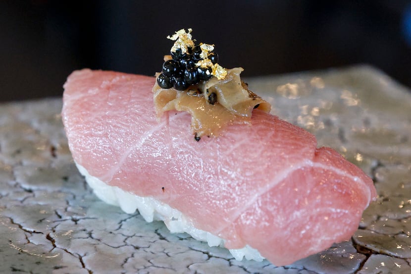Signature tuna belly from Japan topped with black caviar and gold flakes at Kinzo Sushi in...