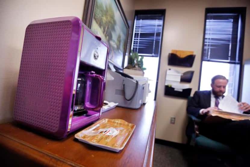 
State District Judge Carter Thompson's coffee machine is even purple, although it’s used...