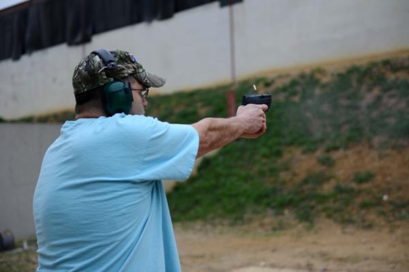 Dallas Pistol Club member Javier Criado shoots a round at the club's Carrollton range on...