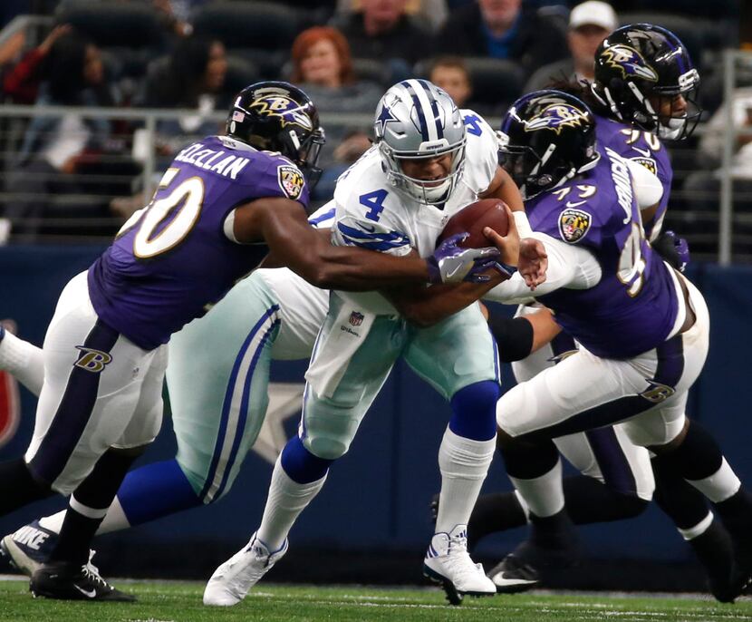 Cowboys quarterback Dak Prescott (4) is pressured by Ravens linebacker Albert McClellan...