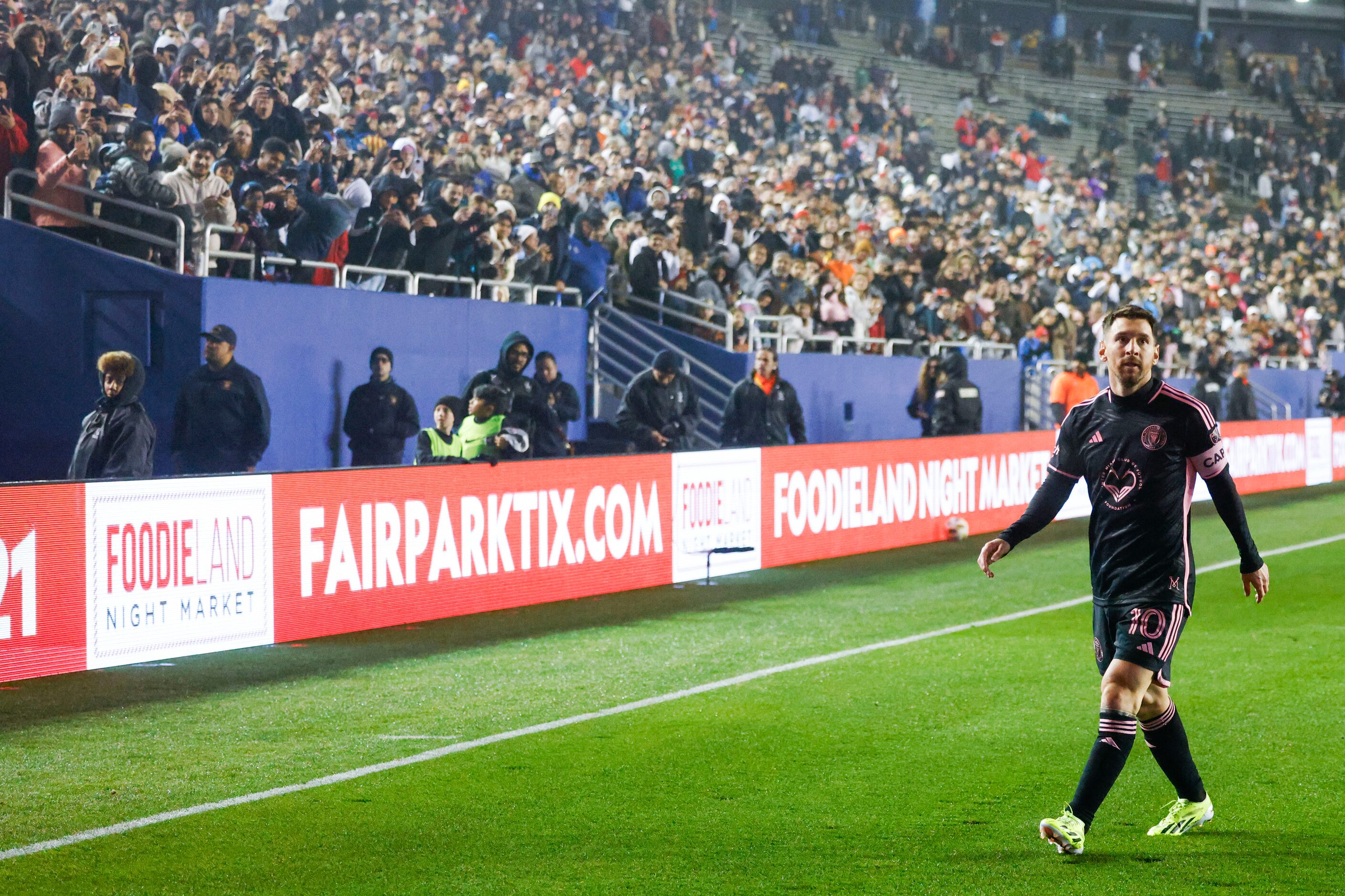 Fans cheer for Inter Miami forward Lionel Messi as he prepares to take a corner kick against...