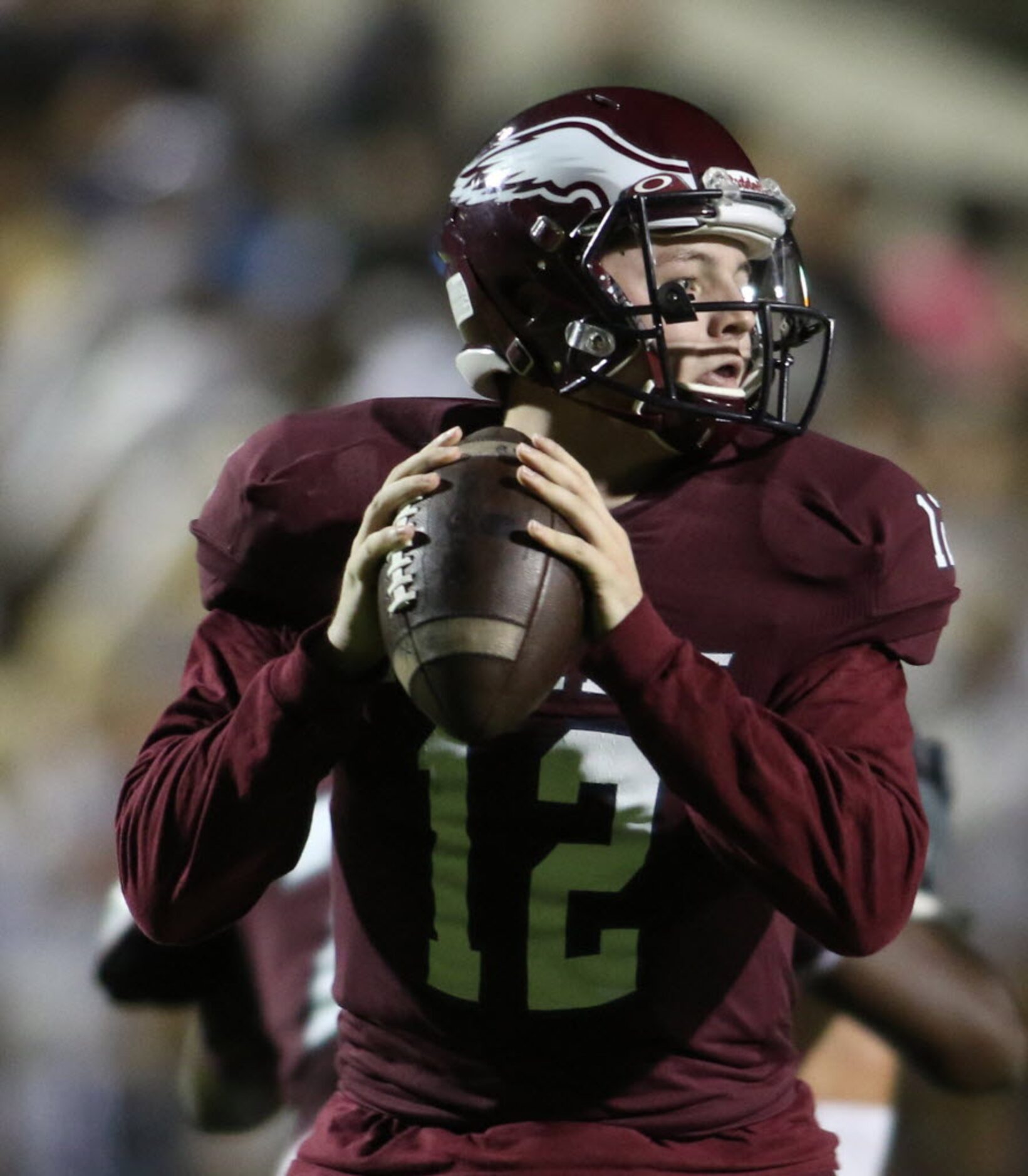 Rowlett quarterback Logan Bonner (12) looks to pass downfield during first quarter action...