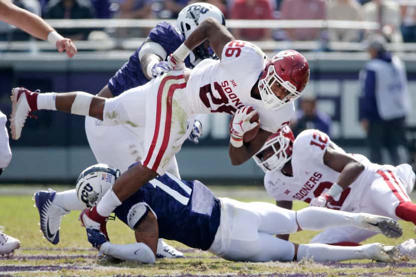 Oklahoma Sooners running back Kennedy Brooks (26) fights for yardage in the third quarter...