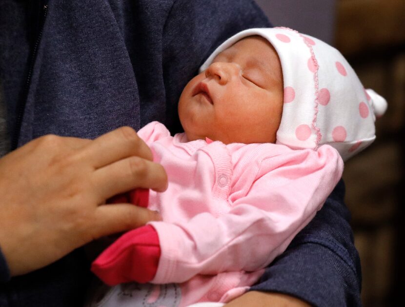 Nora Uribe holds her newborn baby daughter, Ximena, at Medical City Plano during a news...