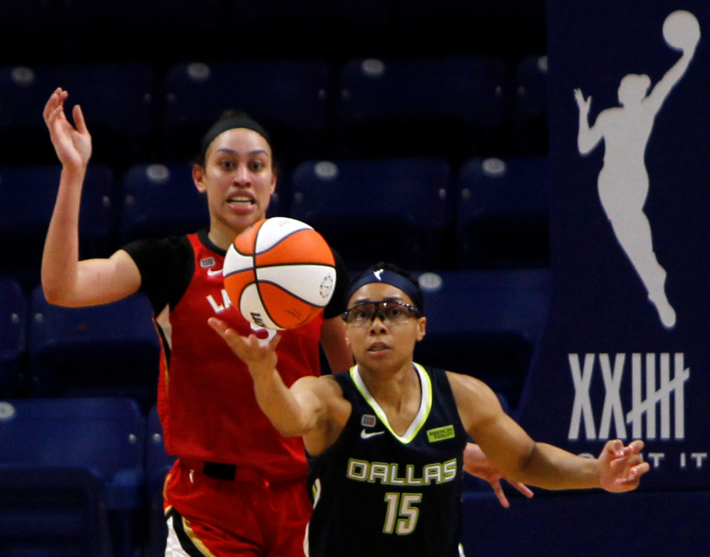 Dallas Wings guard Allisha Gray (15) reaches for a rebound as Las Vegas forward Dearica...