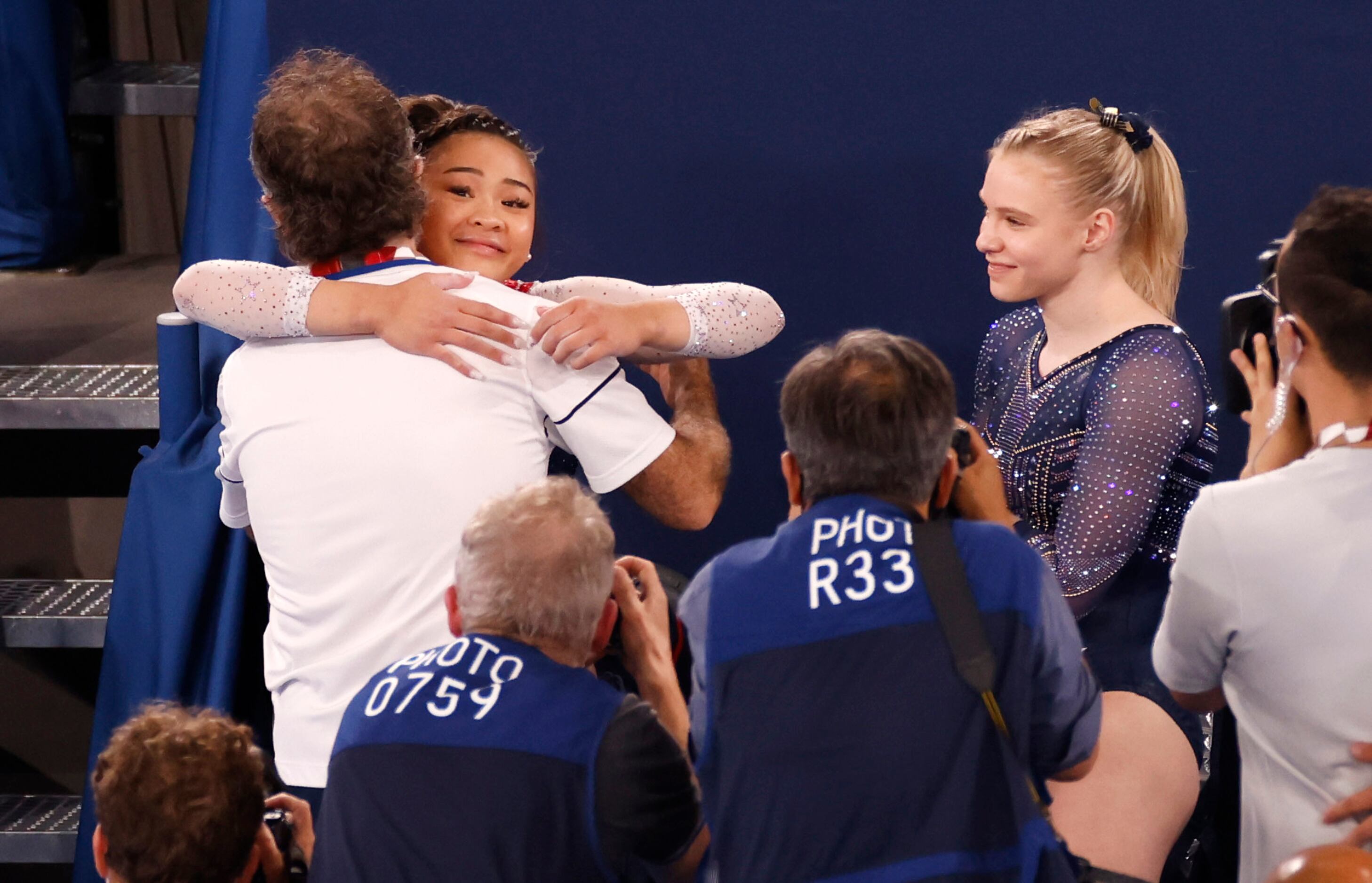 USA’s Sunisa Lee hugs her coach Jeff Graba after receiving her score on her floor routine...