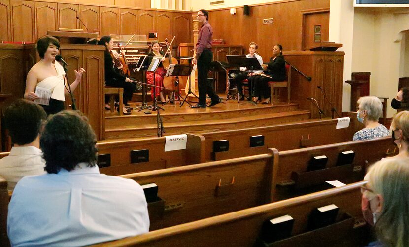 Harpist Emily Levin (left) gives background on the music being played during "Ascents and...