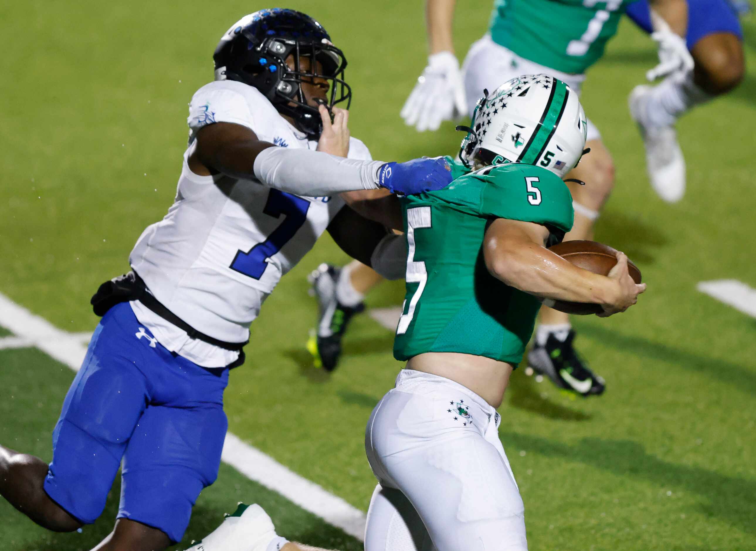 Southlake Carroll running back James Lehman (5) gives a stiff arm to Byron Nelson’s David...