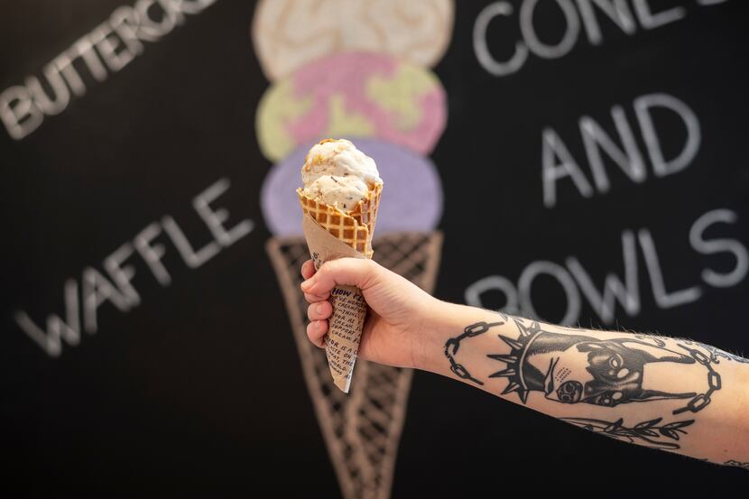 Shop keeper Ellyn McDonald holds a waffle cone with scoops of Gooey Butter Cake and Salted...
