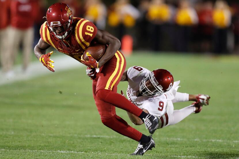 Iowa State wide receiver Hakeem Butler (18) is tackled by Oklahoma cornerback Jordan Parker...