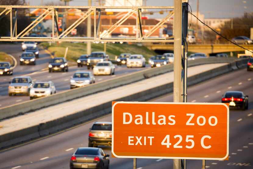 Traffic on I-35E passes a sign marking the exit for the Dallas Zoo on Thursday, Jan. 14,...