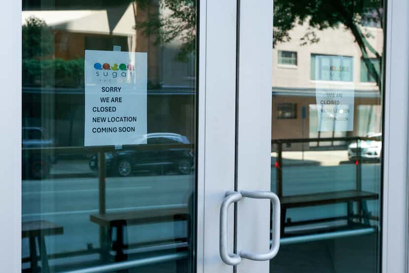 Signs posted at the entrance to Sugar Factory in Uptown Dallas show the restaurant is closed.