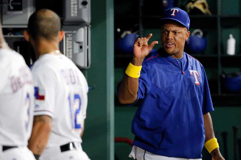 Texas Rangers' Adrian Beltre, right, talks with Rougned Odor (12) in the dugout during the...