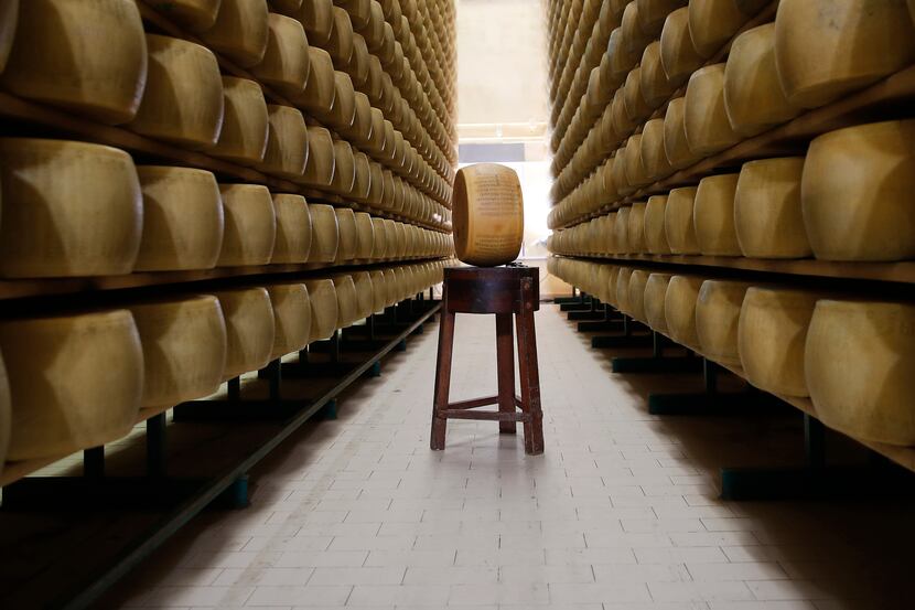 In this photo taken Tuesday, Oct. 8, 2019, Parmigiano Reggiano Parmesan cheese wheels are...