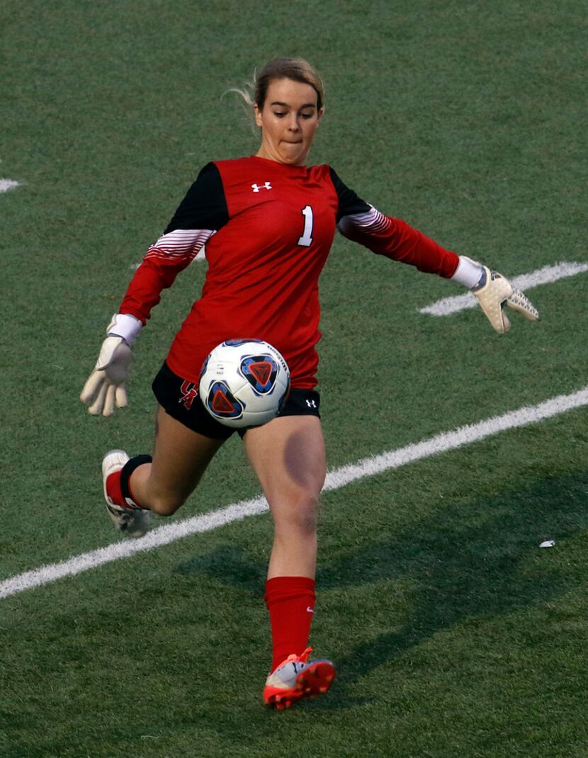 Ursuline goalie Reagan Byers (1) clears the ball after stopping a John Paul ll player's shot...