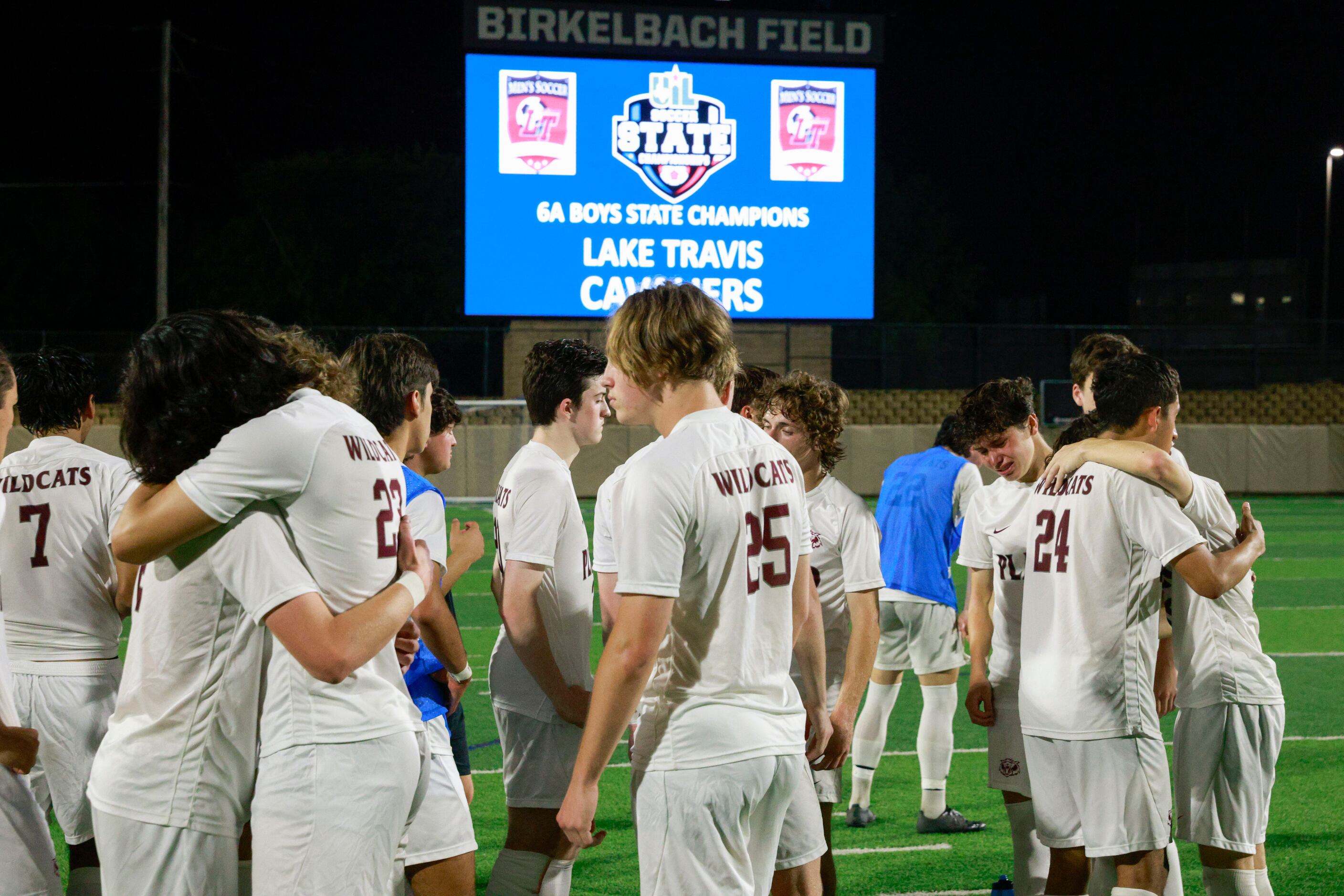 Plano players comfort each other after losing the Class 6A boys soccer state championship at...