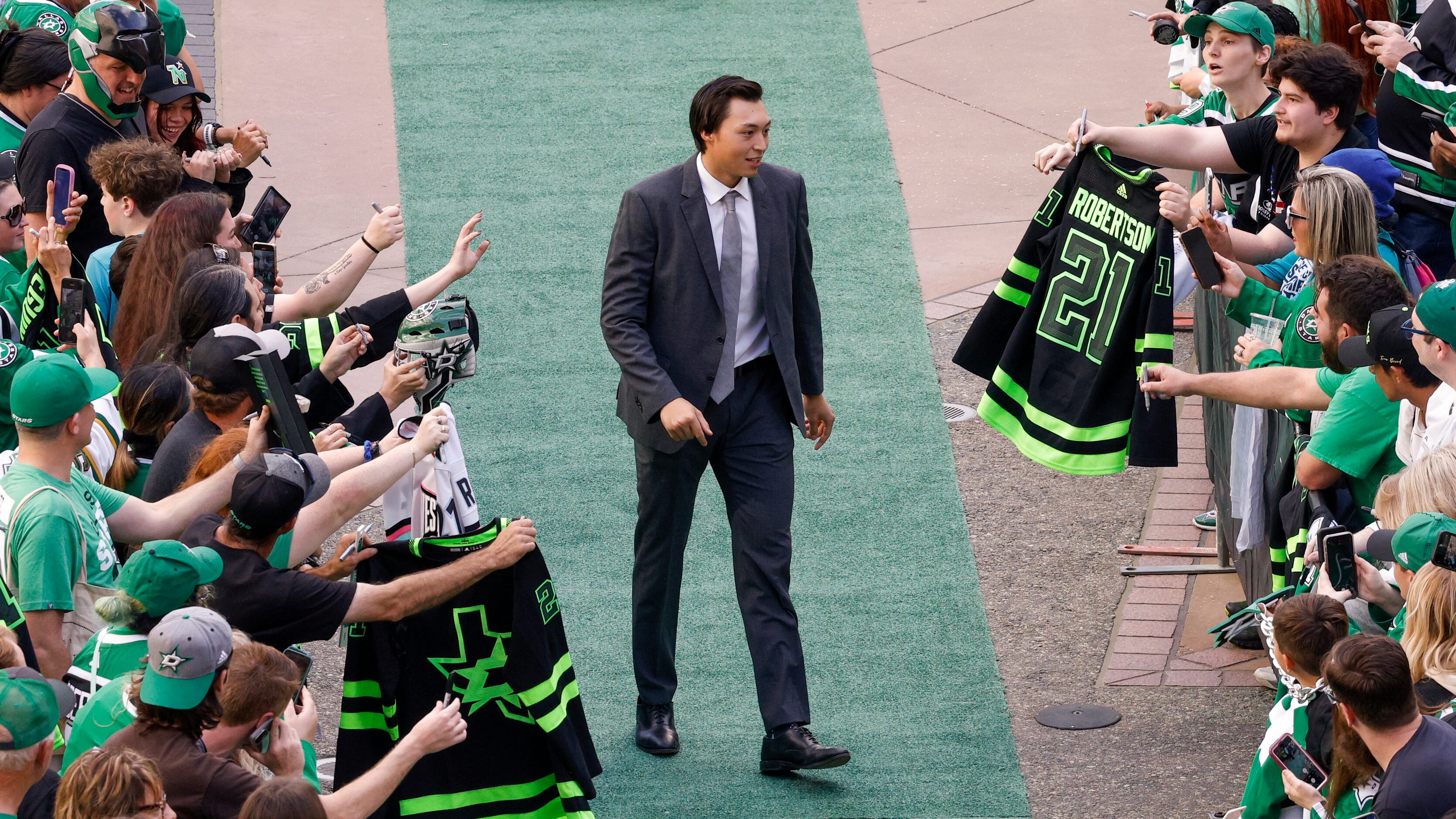 Dallas Stars left wing Jason Robertson greets fans on the green carpet to the American...