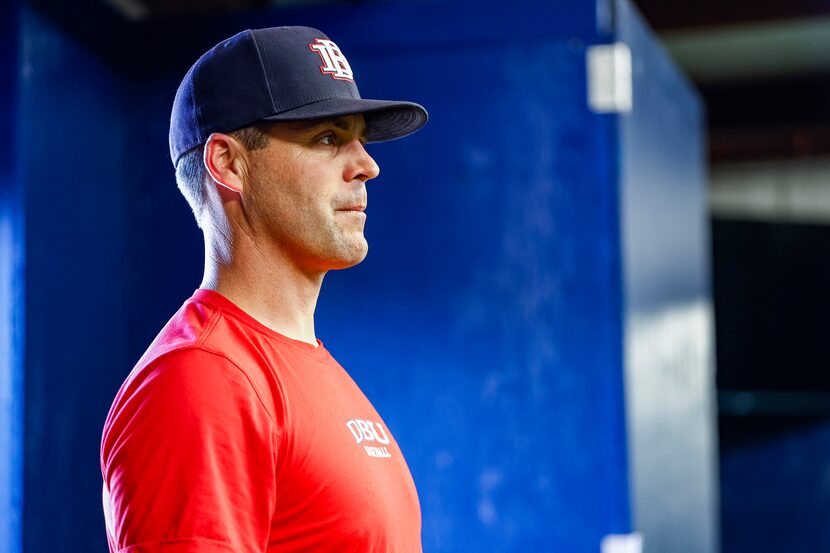 Dallas Baptist University baseball head coach Dan Heefner watches as his players take...