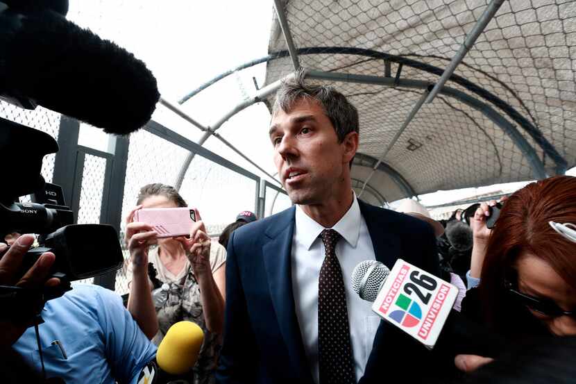 Democratic presidential candidate Beto O'Rourke is surrounded by reporters as he walks on an...