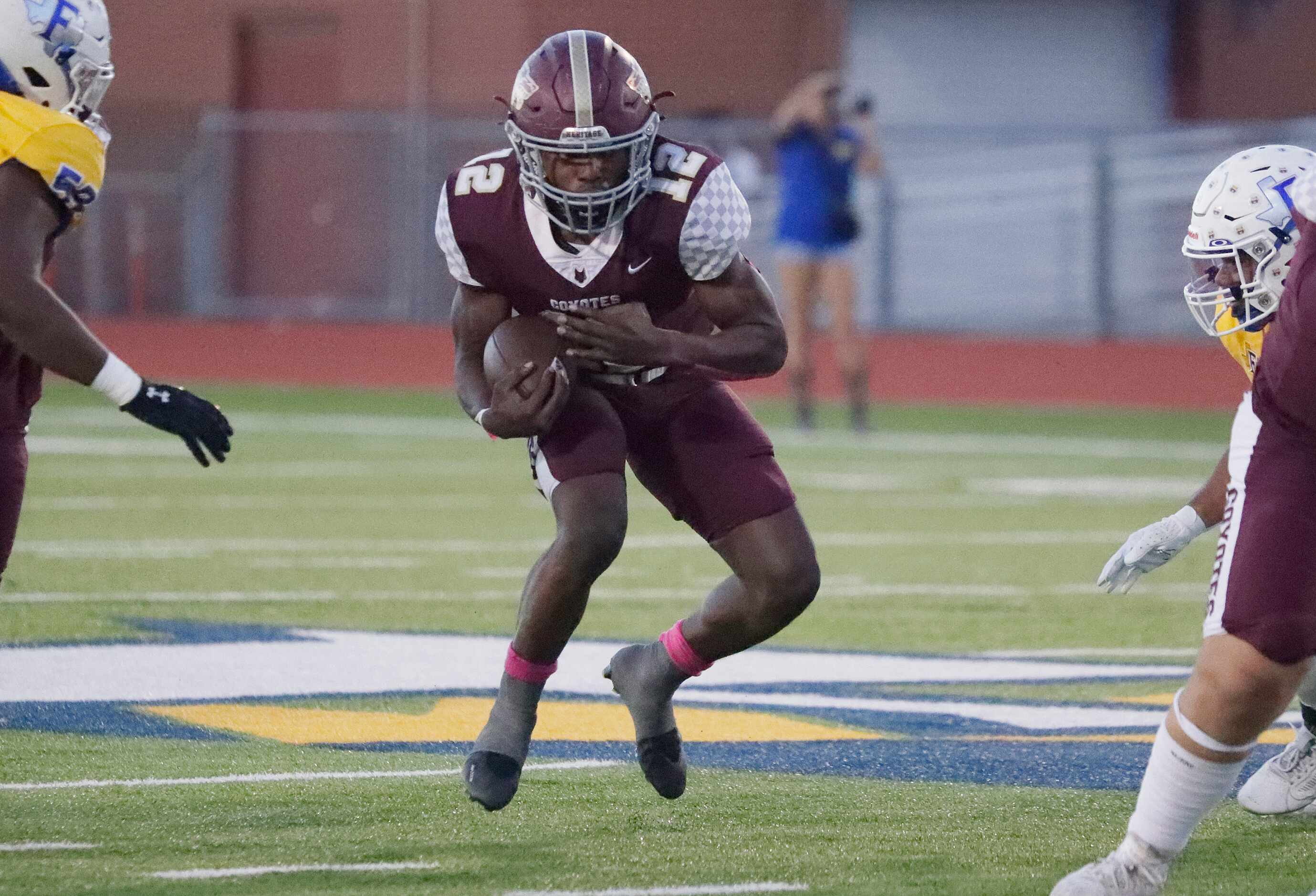 Frisco Heritage High School running back Kentra Britton (12) carries the ball during the...