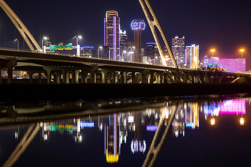 The downtown Dallas skyline is seen behind the Margaret McDermott Bridge.