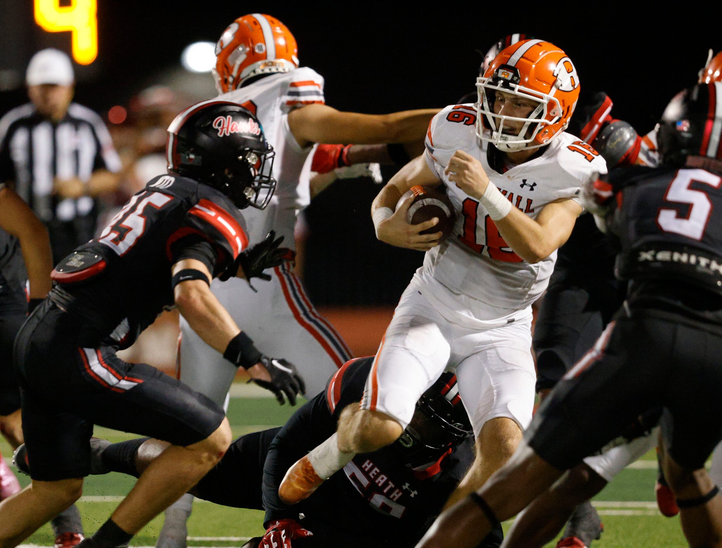 Rockwall's quarterback Mason Marshall (16) keeps a ball away from Rockwall-Heath's Chase...