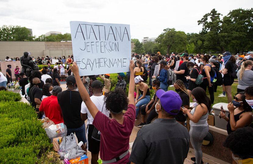 Among the signs held Sunday at the Freedman's Cemetery demonstration was one referencing...