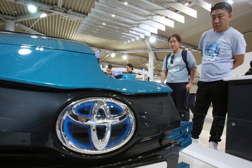 Visitors inspect Car at Toyota showroom in Tokyo, Wednesday, May 8, 2019. Japan's top...