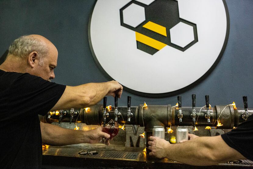 Owner Gary Gordon, left, and Blake Gordon pour mead at Breaking Brew Meadery.