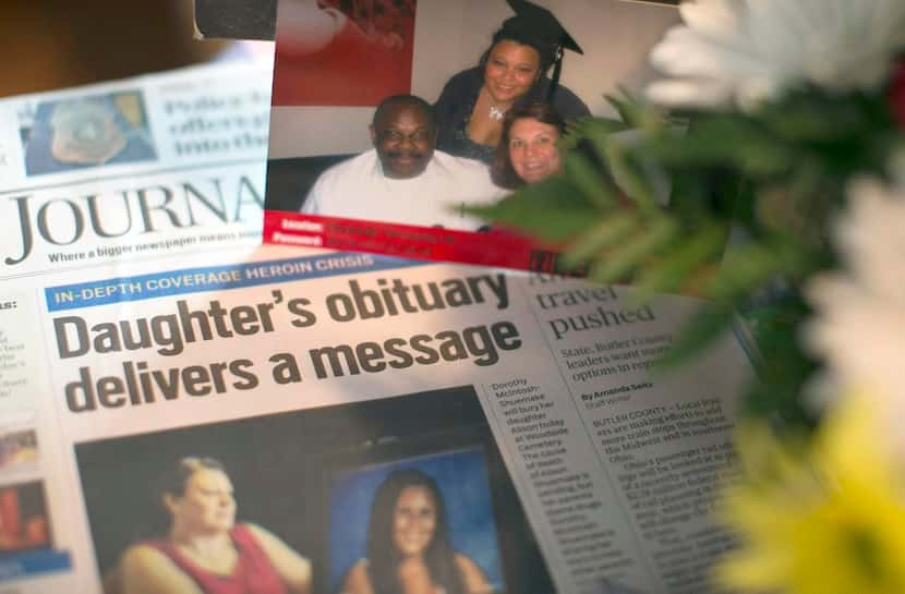 A high school graduation picture  of Alison rests next to a newspaper at the family’s home.