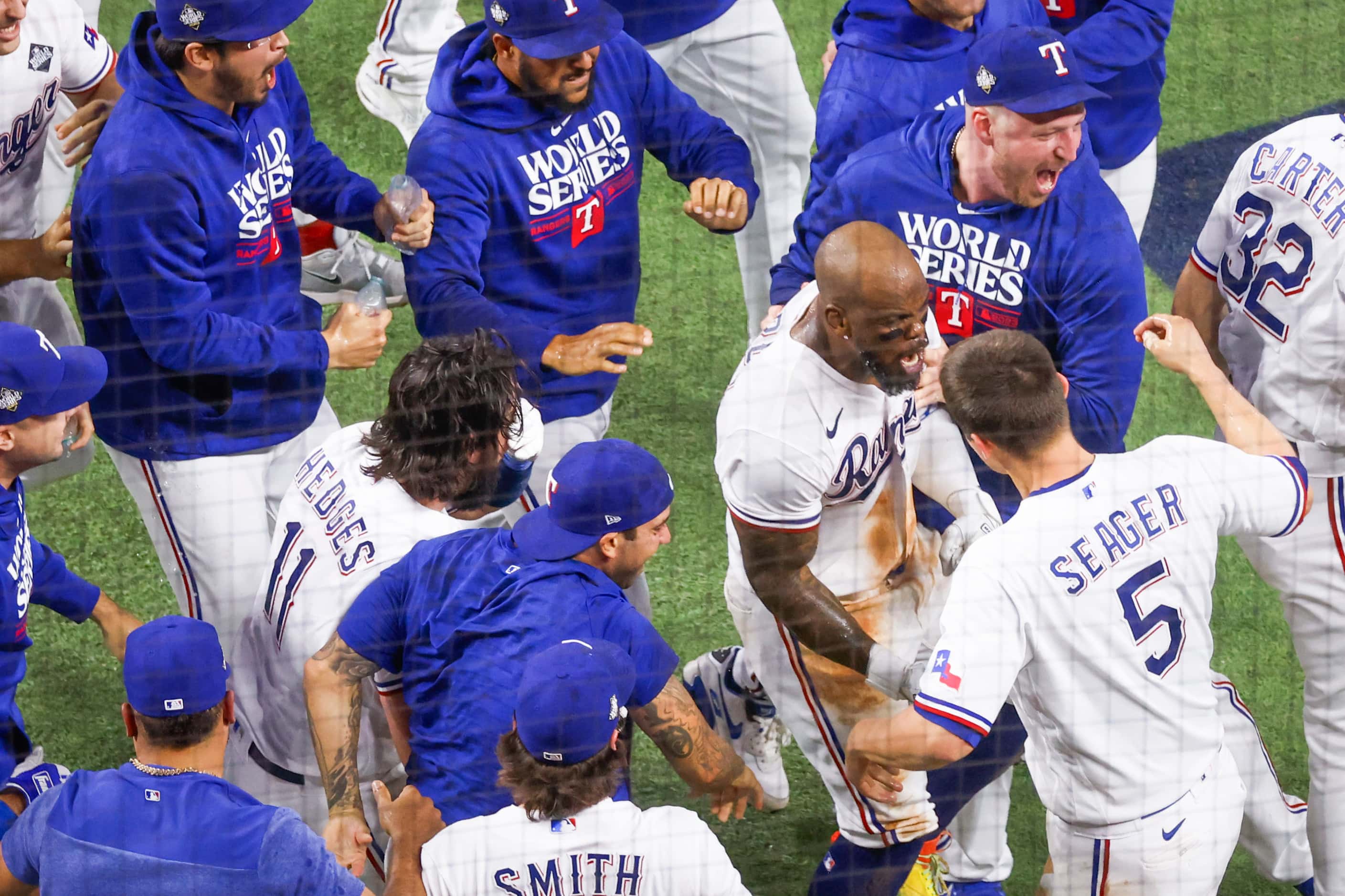 Texas Rangers right fielder Adolis Garcia (center) celebrates with his teammates after...