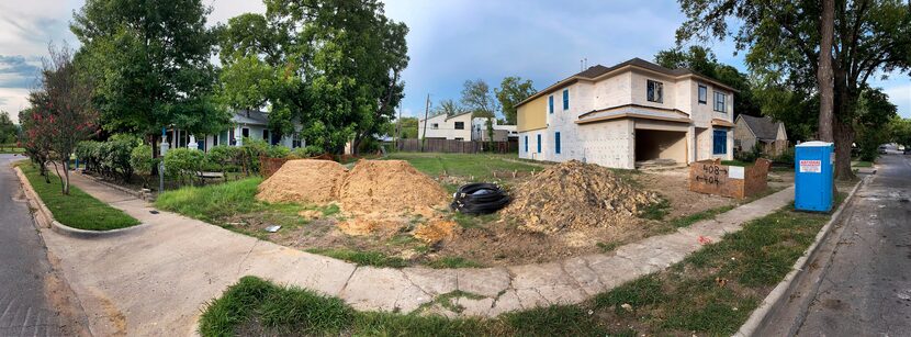 A panoramic view shows a block in which one original-construction house still stands near...