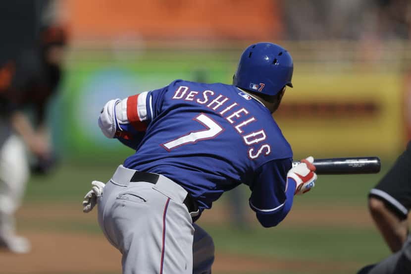 Texas Rangers' Delino DeShields Jr. bunts on a pitch from San Francisco Giants' Jake Peavy...