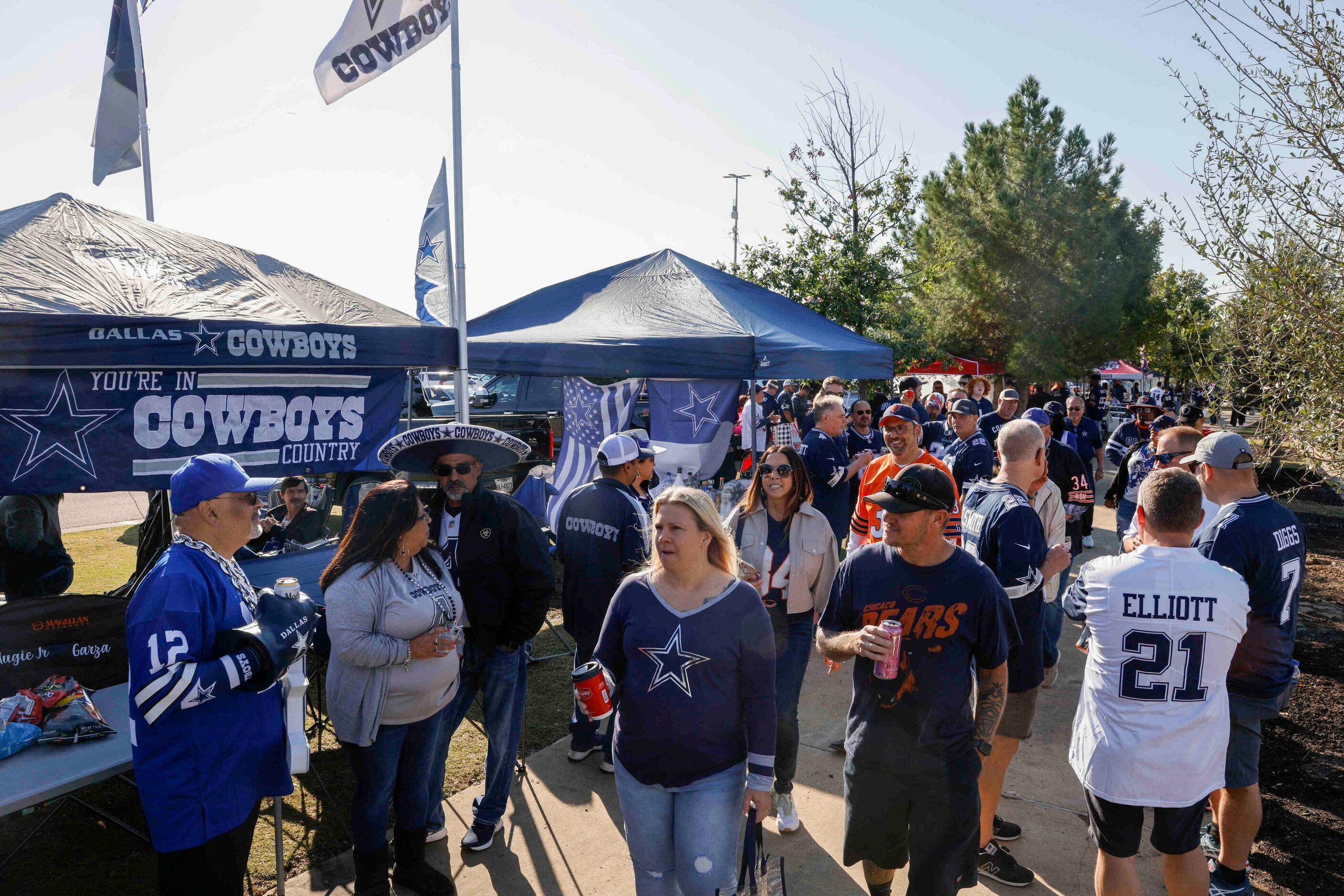 Football fans tailgate before an NFL game between the Dallas Cowboys and the Chicago Bears...